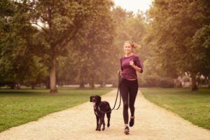 woman-running-in-the-park-with-a-dog